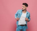 Man holding his denim shirt`s collar and looking to side Royalty Free Stock Photo