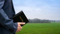 Man holding Bible in his hand. Concept for faith, spirituality and religion. Royalty Free Stock Photo