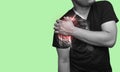 Man holding his injured shoulder that`s highlighted in red. Medical concept