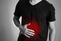 The man is holding his stomach. Abdominal pain. The hearth is hi Royalty Free Stock Photo