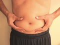 Man is holding his too fat tummy Royalty Free Stock Photo