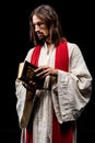 Man holding holy bible isolated on black Royalty Free Stock Photo