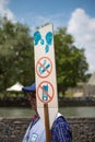 Man holding a holy sign board in Lourdes