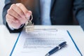 Man holding home key during signing home contract documents. Contract agreement, real estate,  buy and sale and insurance concepts Royalty Free Stock Photo