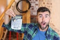 Man holding house keys and calculator