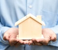 Man holding house representing home ownership Royalty Free Stock Photo