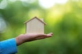 Man holding house representing home ownership and saving money Royalty Free Stock Photo