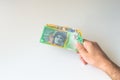 Man holding hundred and fifty Australian Dollar in his Royalty Free Stock Photo