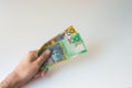 Man holding hundred and fifty Australian Dollar in his Royalty Free Stock Photo