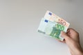 Man holding a hundred and fifty Euro banknote Royalty Free Stock Photo