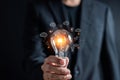 Man holding illuminated lightbulb glowing to Starting New idea, innovation and inspiration, smart intelligent creativity,