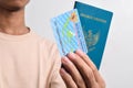 Man holding Indonesian Passport and Indonesian identity cards (KTP)