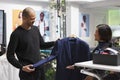 Man holding jacket in clothing store Royalty Free Stock Photo