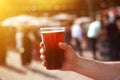 Man holding a jar of dark beer in his hand at the beer and food street festival Royalty Free Stock Photo