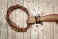 Man Holding Jesus Crown Thorns with His Hand and Many Handcuffs. Royalty Free Stock Photo