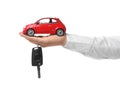 Man holding key and miniature automobile model on background, closeup. Car buying Royalty Free Stock Photo