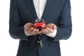 Man holding key and miniature automobile model on background, closeup. Car buying Royalty Free Stock Photo