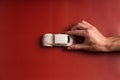 Man holding key and miniature automobile model on white background, closeup. Car buying Royalty Free Stock Photo