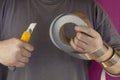 Man is holding a knife with interchangeable blades and aluminum tape