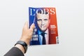 Man holding L`Obs magazine newspaper with Emmanuel Macron on fir