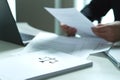 Man holding a legal document in hand.