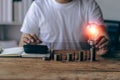 man holding light bulb on fire with pile of coins Calculator notebook on desk for saving energy, money concept Royalty Free Stock Photo