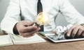 Man holding light bulb in his desk. Idea concept Royalty Free Stock Photo