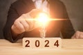 Man holding light bulb on 2024 year. business idea growth and investment. 2024 New Year Business Idea, Creative Royalty Free Stock Photo