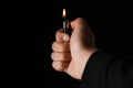 Man holding lighter on black background, closeup Royalty Free Stock Photo