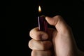 Man holding lighter on black background, closeup Royalty Free Stock Photo