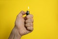 Man holding lighter on yellow background, closeup. Space for text Royalty Free Stock Photo