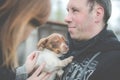 Man holding little puppy dog Royalty Free Stock Photo