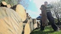 Man holding log carryin on pile low angle