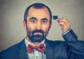 Man holding Micro SD card near his head Royalty Free Stock Photo