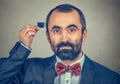 Man holding Micro SD card near his head Royalty Free Stock Photo