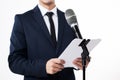 Man holding microphone and clipboard on white background. Generate Ai Royalty Free Stock Photo