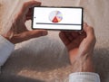 A man holding a mobile in his hands. The display of the mobile shows a pie chart Royalty Free Stock Photo