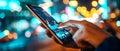 A man holding a mobile phone in his hands. A person using fintech software in his smart phone.