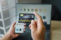 Man holding mock up credit card with number using smartphone and laptop computer for shopping.Online shopping concept Royalty Free Stock Photo