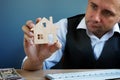 Man holding model of home. Property investment and house mortgage