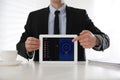 Man holding modern tablet with switched on VPN at white table in office, closeup