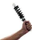 Man holding motorcycle shock absorber back lit