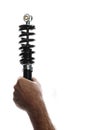 Man holding motorcycle shock absorber back lit over white