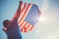 Man holding national USA flag. Celebrating Independence Day of America. July 4th Royalty Free Stock Photo
