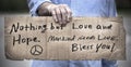 Man holding, Nothing But Love and Hope, handwritten cardboard sign, closeup, inspiration