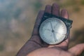 Man holding an old compass showing direction. Royalty Free Stock Photo