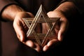 A man holding an old and rusty star of David in their hands. Royalty Free Stock Photo