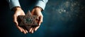 A man holding an old and rusty star of David in their hands on ruins background. Royalty Free Stock Photo