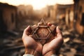 A man holding an old and rusty star of David in their hands on ruins background. Royalty Free Stock Photo