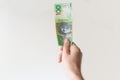 Man holding one hundred Australian Dollar note in his hand Royalty Free Stock Photo